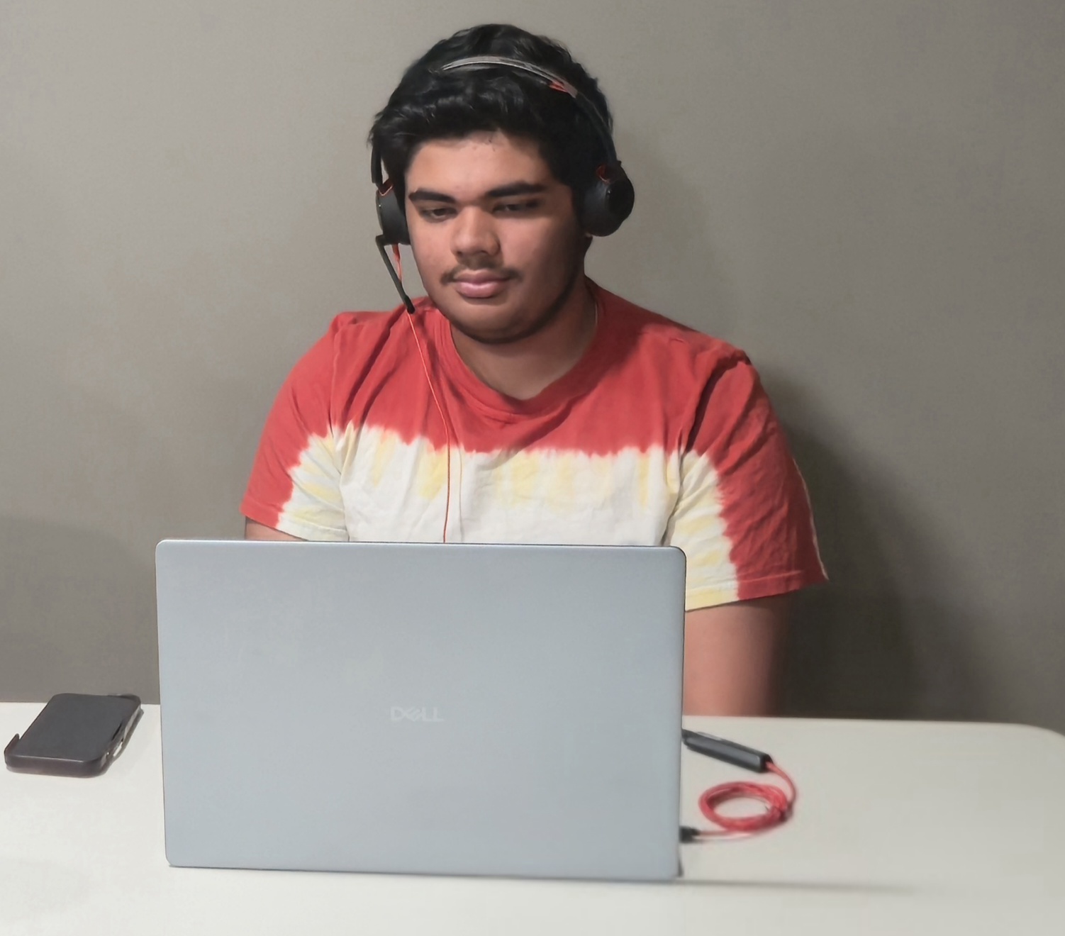 A Camp Director wearing a headset, teaching a session from a laptop
