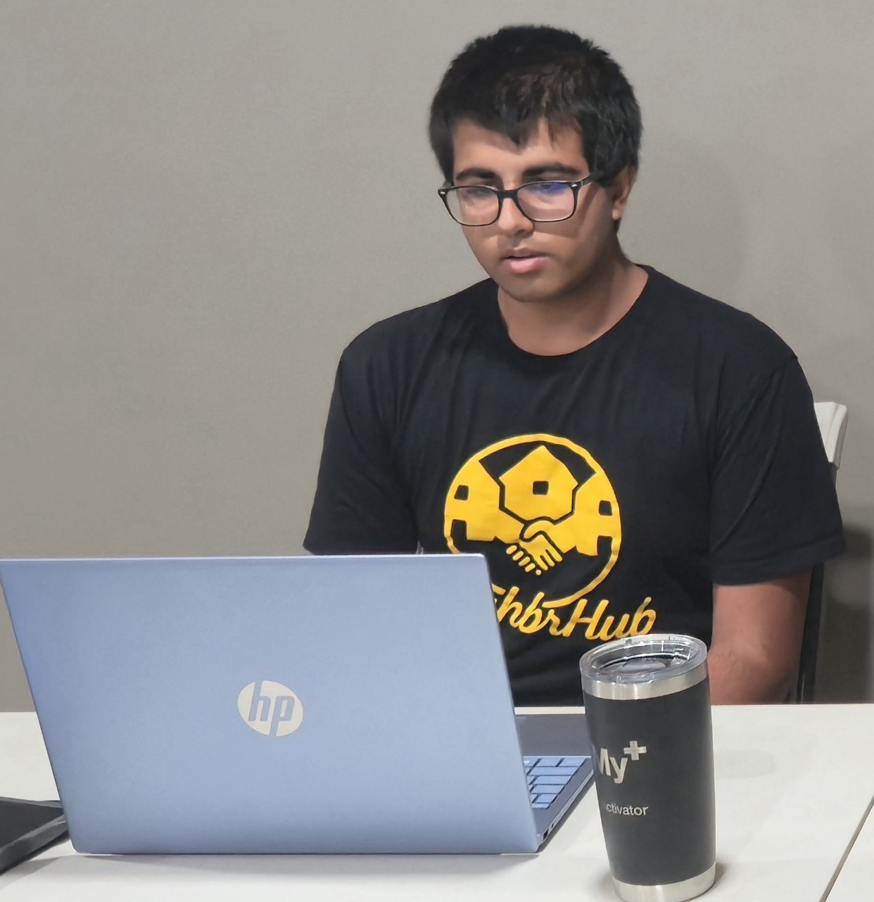 A Camp Director working at a laptop before a session