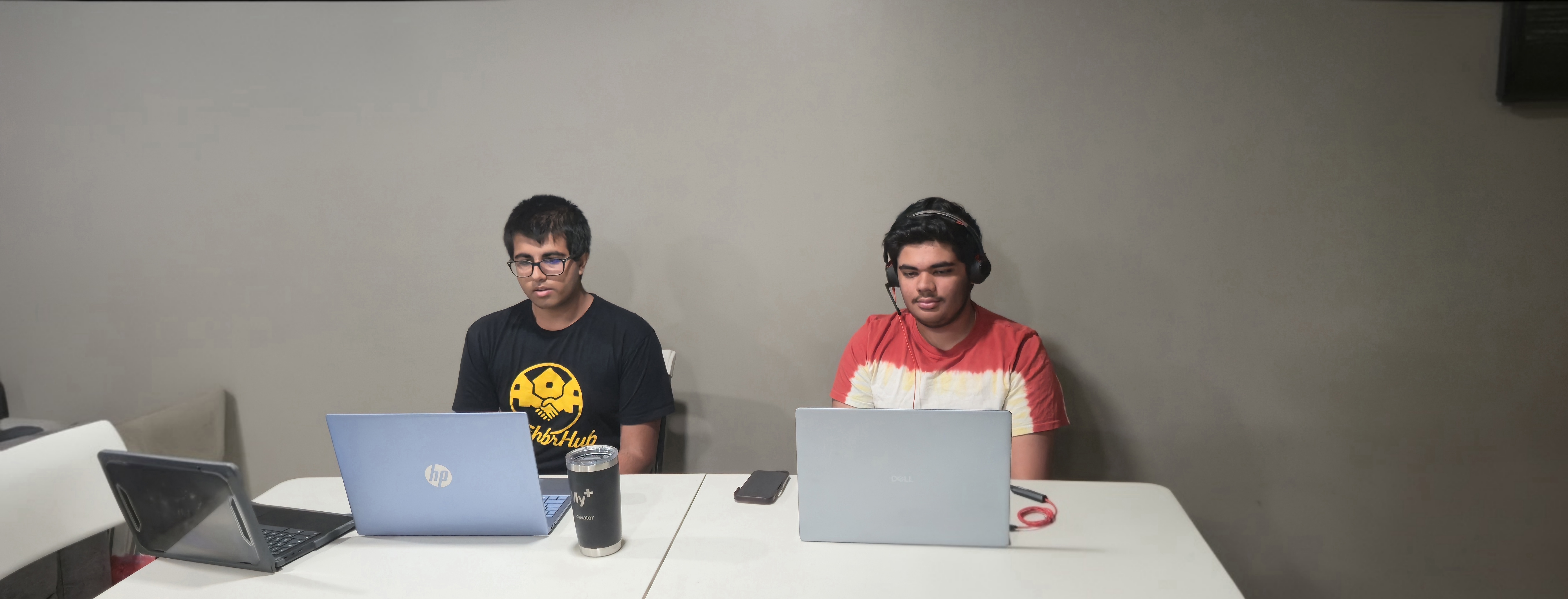 Two Camp Directors sitting side by side at their laptops